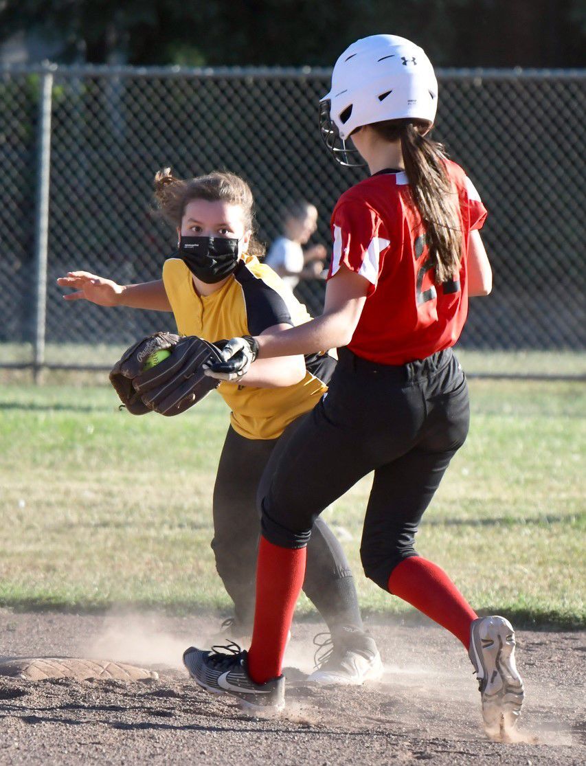 R.E. Maher Construction's Alexis Lund, left, tags out Soscol Auto Body's Makenzie Matoza